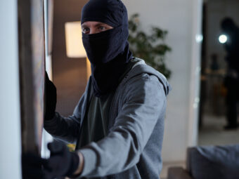 Criminal Wearing Mask Stealing Painting during Home Burglary