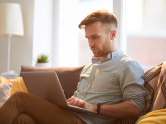 Handsome Man Using Laptop at Home